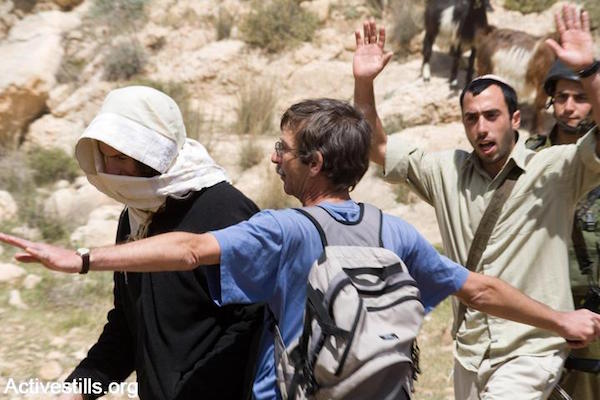 Ta'ayush volunteer protecting Palestinian shepherd