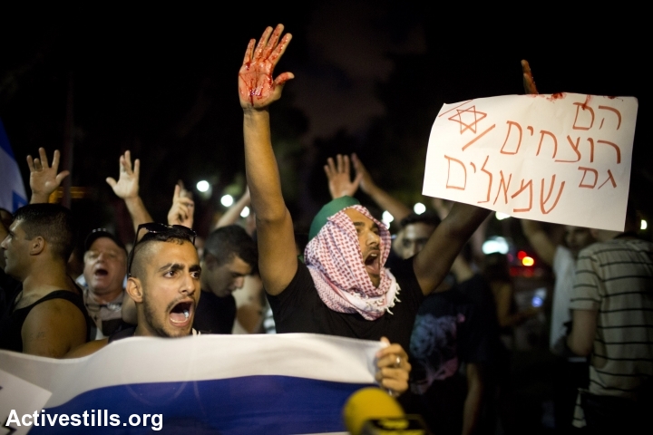 Israeli right-wing activists protest a Breaking the Silence demonstration against the 2014 Gaza war, Tel Aviv, July 17, 2014. (Oren Ziv/Activestills.org)